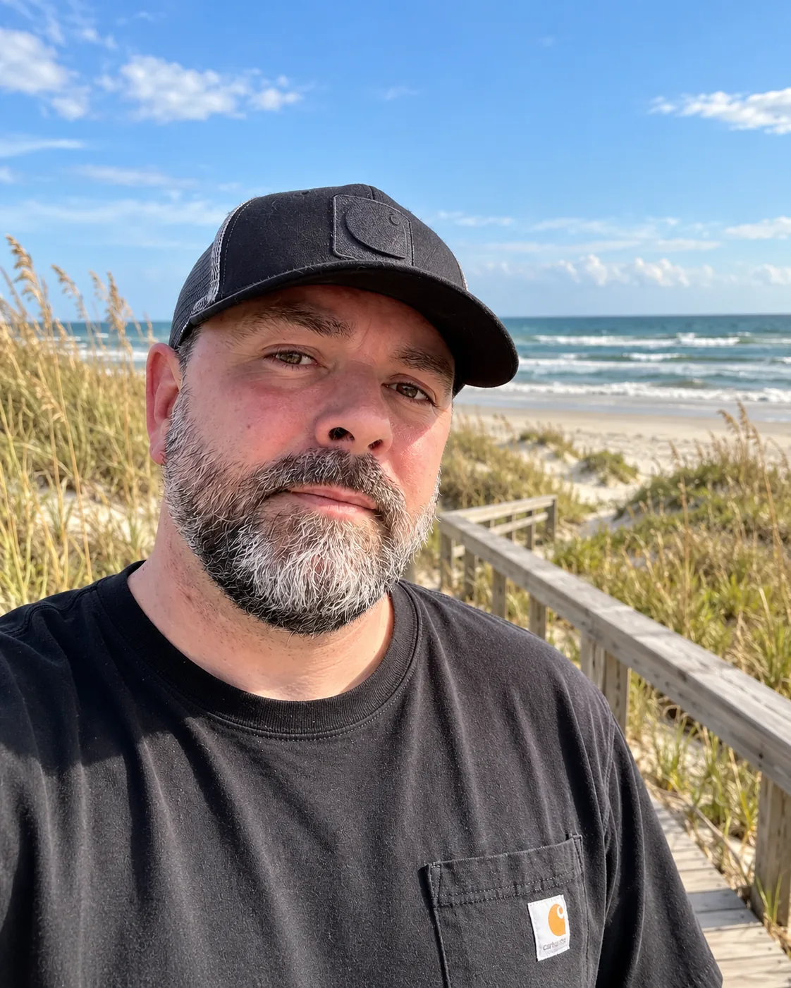 Jason Coldham on a coastal boardwalk by the beach